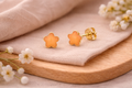 Children's star-shaped earring with delicate orange resin, 18k gold plated, hypoallergenic.