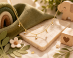 Children's necklace with five dangling pearls, plated in hypoallergenic 18k gold.
