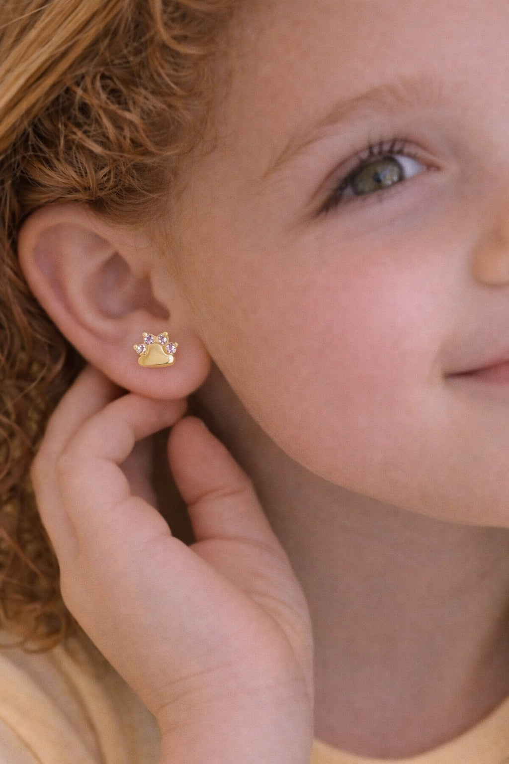 Delicate children's earring with paw-shaped studs, 18k gold plated and set with cubic zirconia.