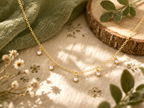 Children's necklace with five dangling pearls, plated in hypoallergenic 18k gold.