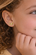 Delicate hypoallergenic children's earring in a bow shape, 18k gold plated.
